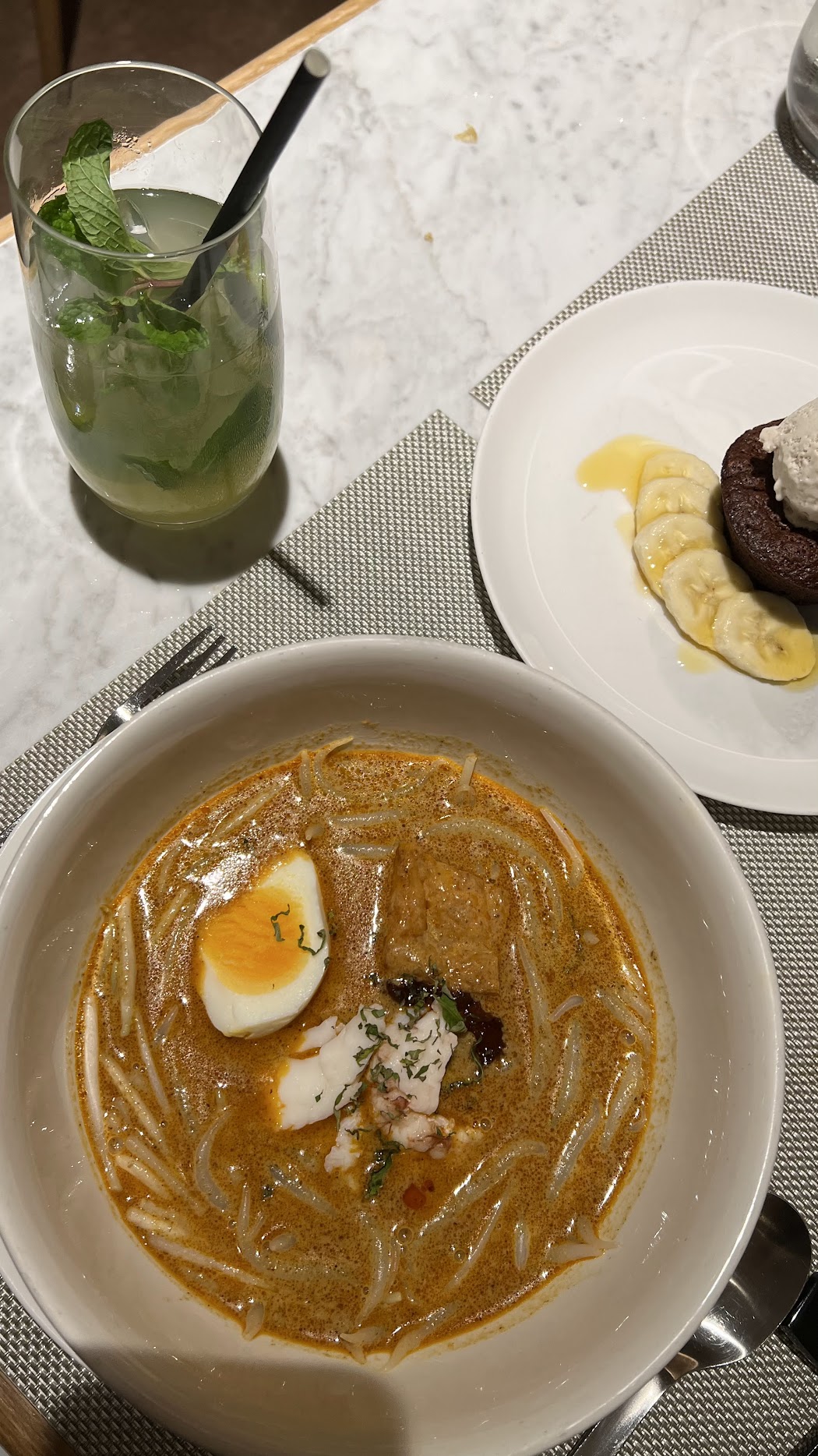 Signature laksa with crayfish and a glass of cocktail