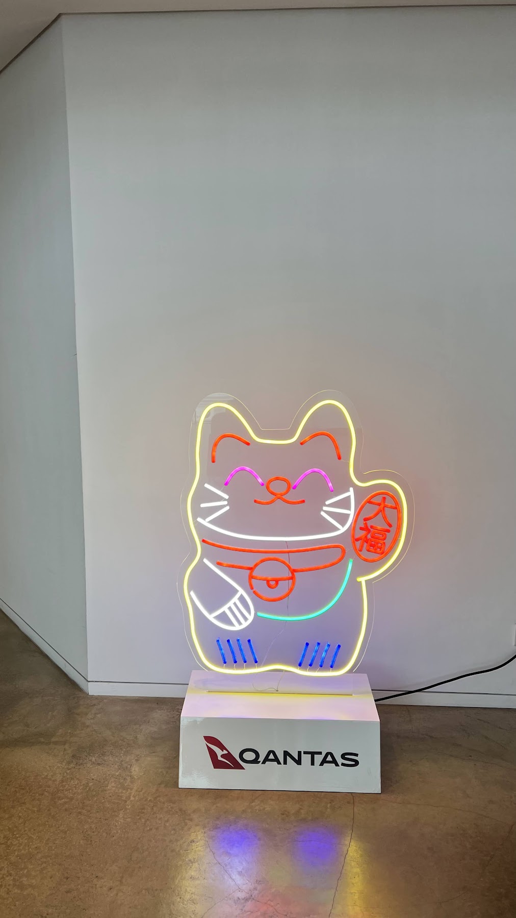 Qantas Lounge Hong Kong fortune cat neon display