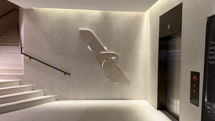 Admirals Club DCA Concourse E's entrance foyer decorated with a stone carving of the American Airlines logo
