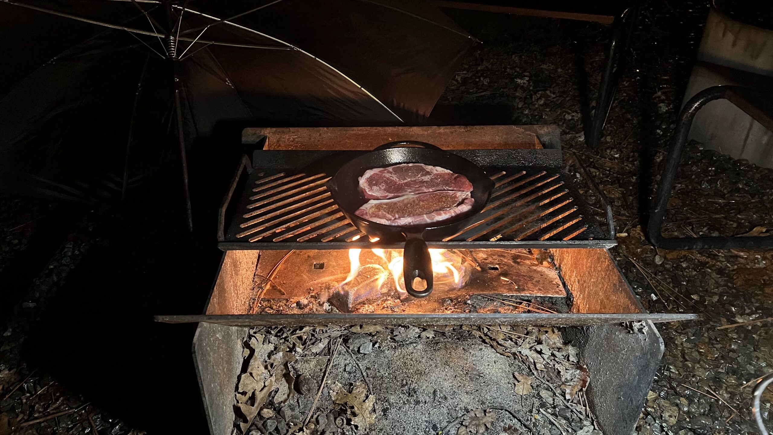 Grilling meat outside our AutoCamp Yosemite Airstream in the rain