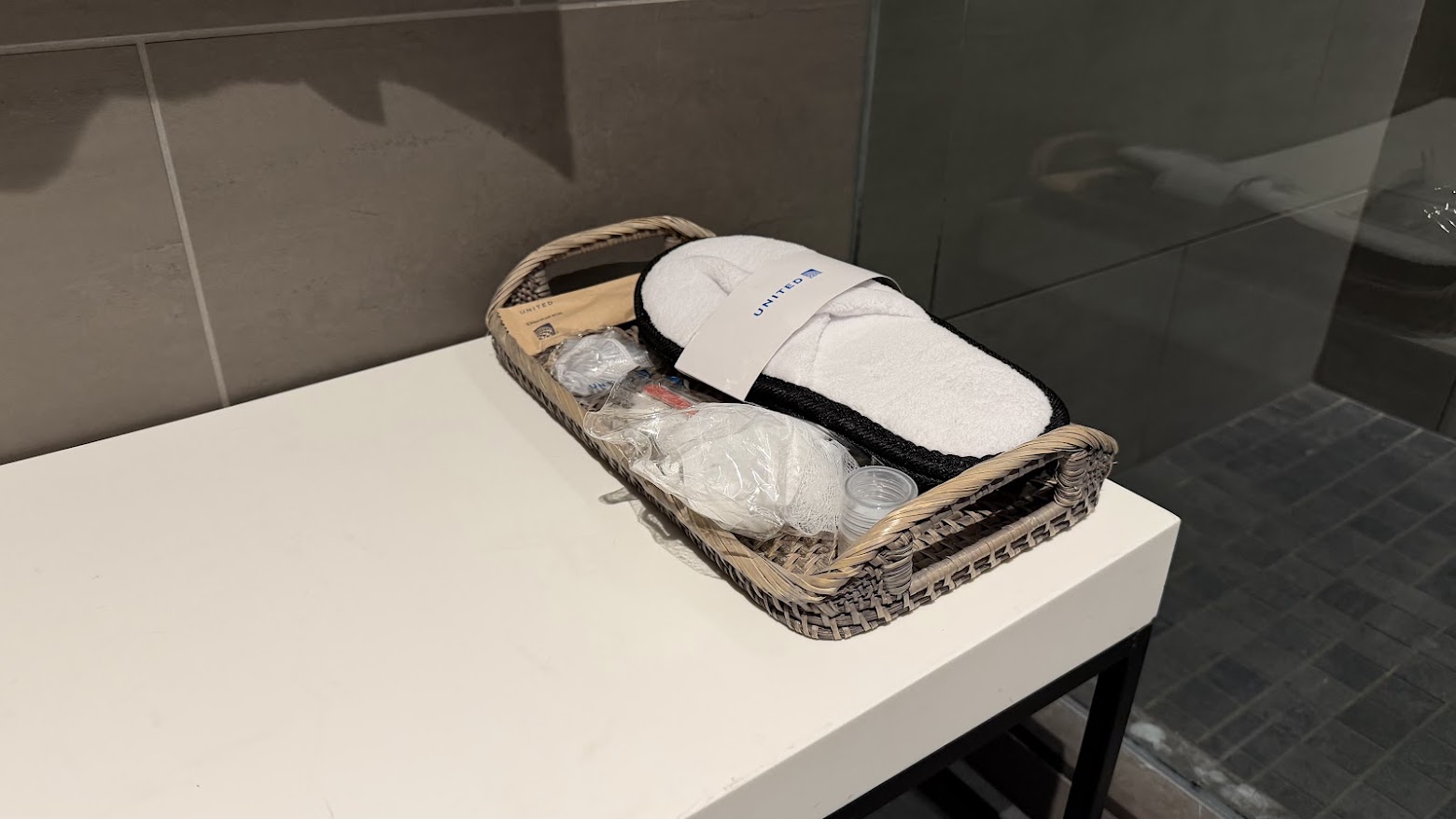 United Polaris Lounge San Francisco shower suite amenity basket with slippers and toiletries