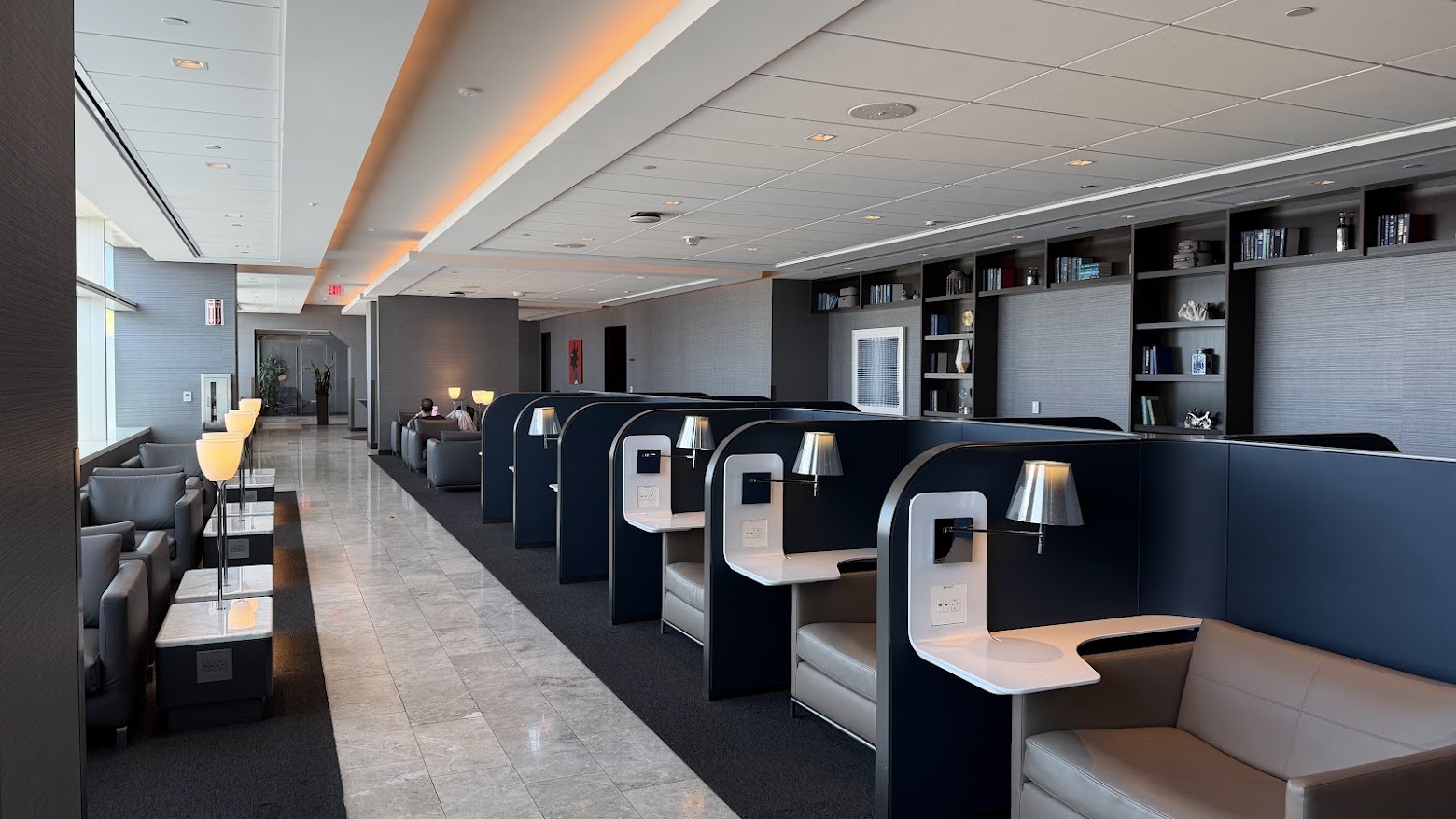 United Polaris Lounge San Francisco productivity pods lining the lower floor hall