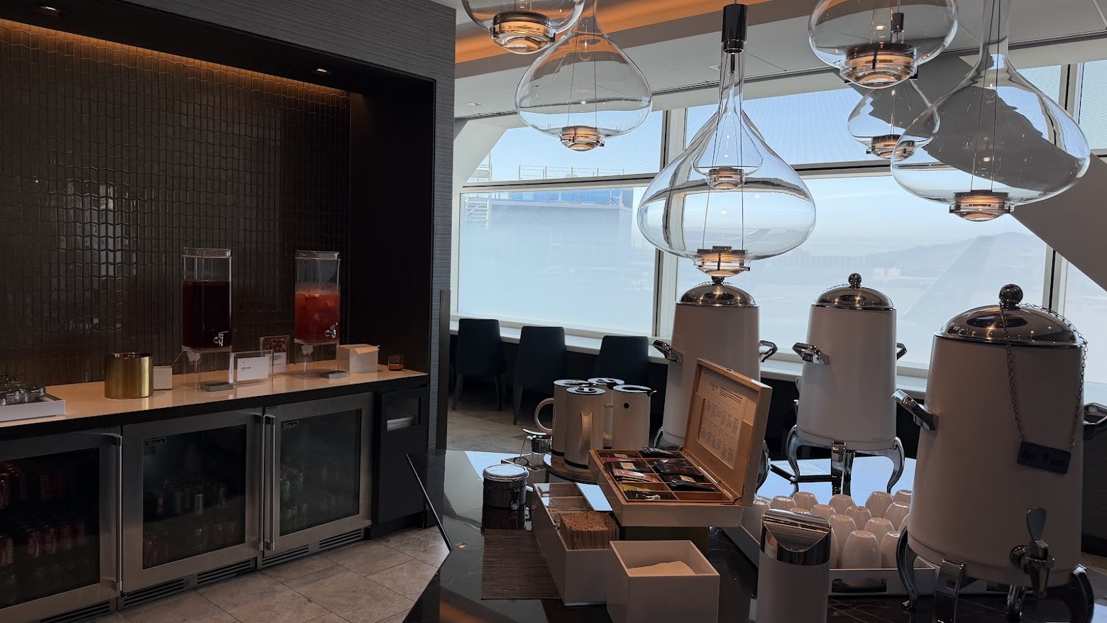 United Polaris Lounge San Francisco lower floor drinks station with juices, beer, and tea