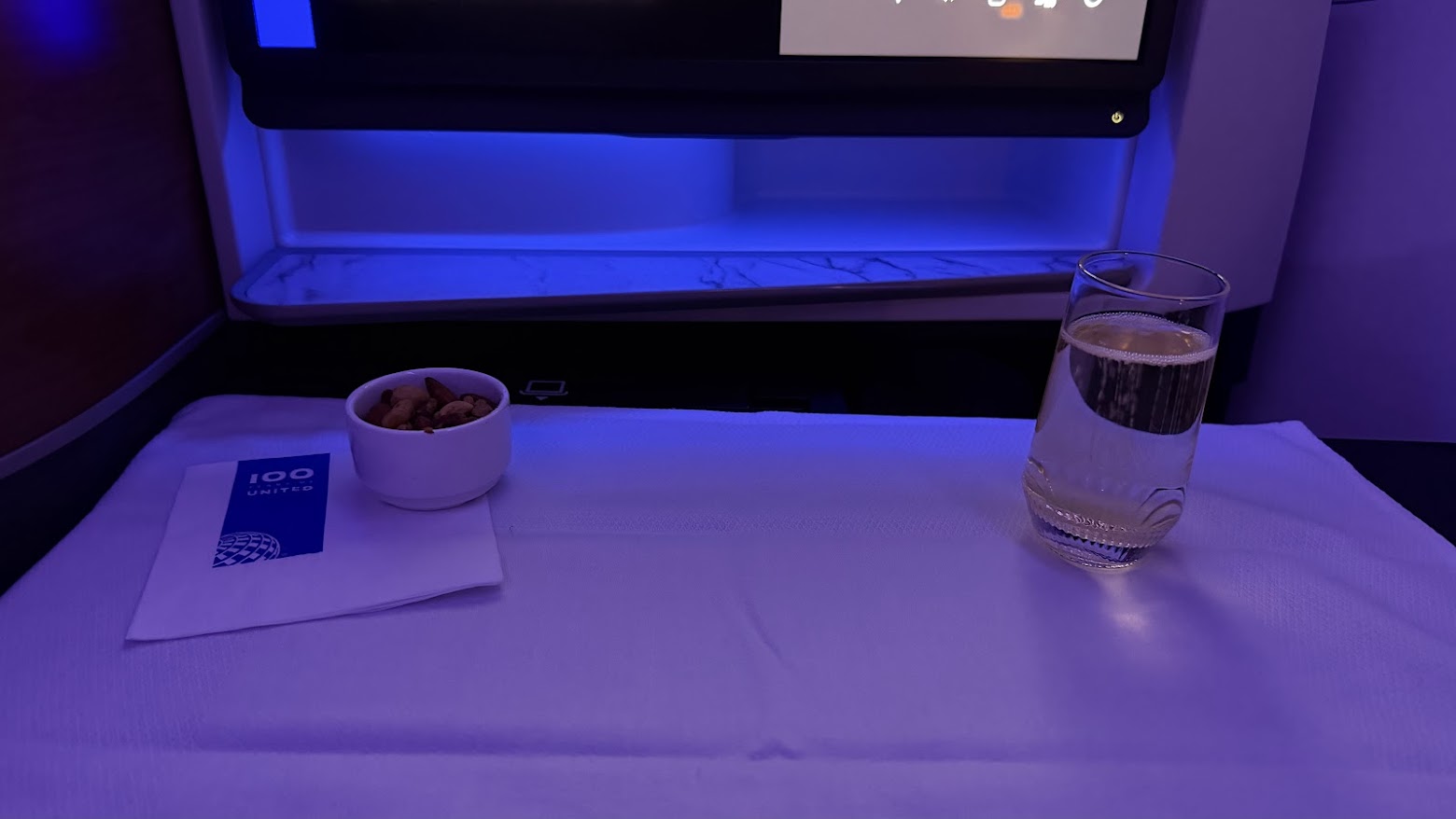 United Airlines UA1 Polaris business class mixed nuts service with champagne