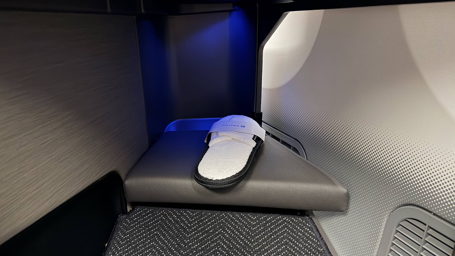 United Airlines UA1 Polaris business class seat footwell with slippers
