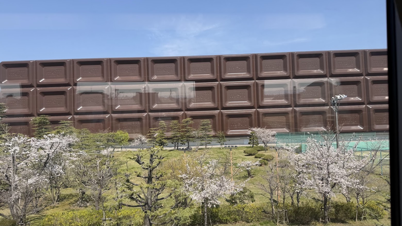 The Meiji chocolate bar near the factory, seen from the train