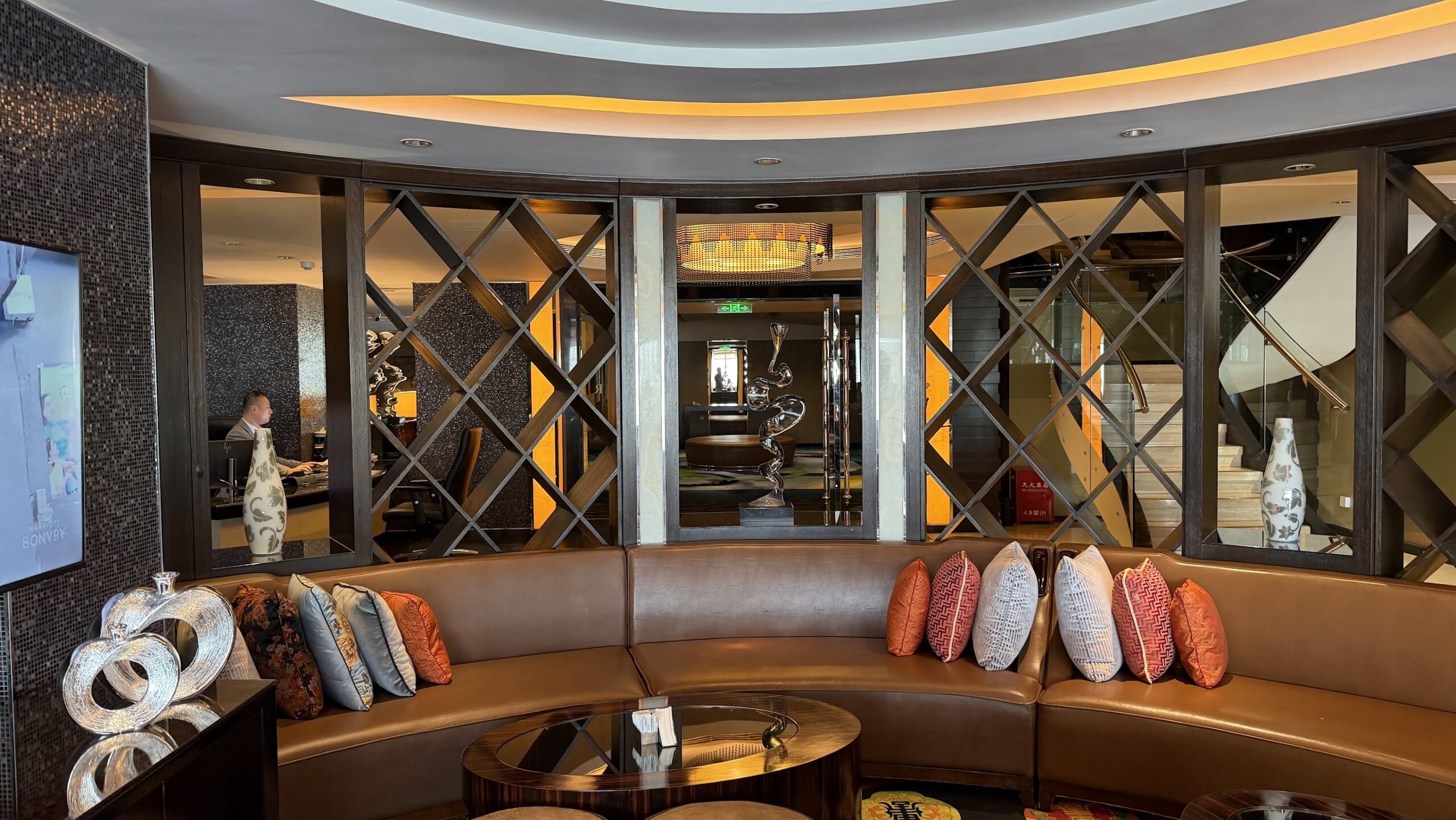 Renaissance Shanghai Yu Garden Hotel Executive Lounge curved sofa with reception and staircase behind