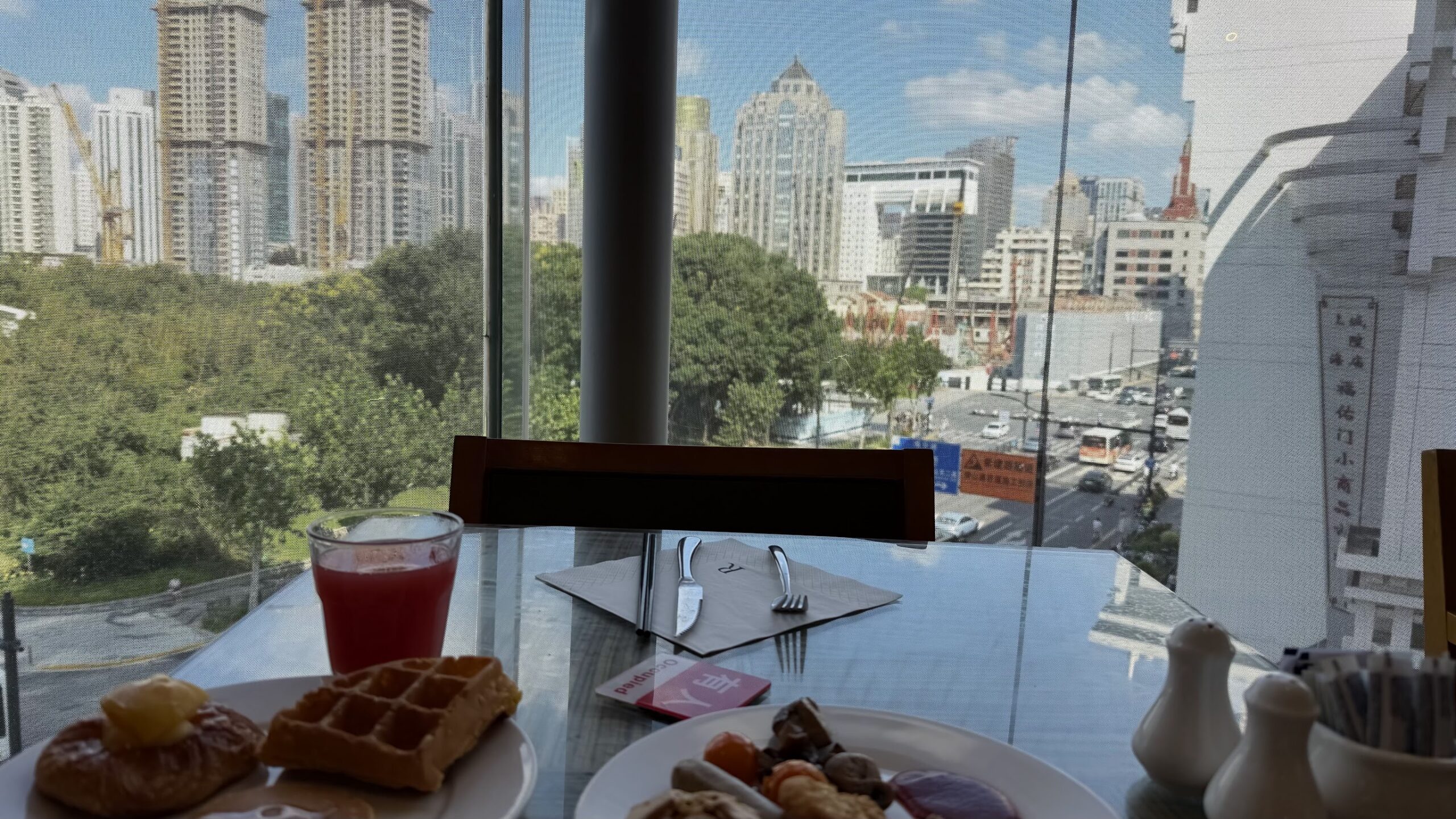 Renaissance Shanghai Yu Garden Hotel Yu Garden Cafe breakfast by the window with waffles, pastries and hot dishes